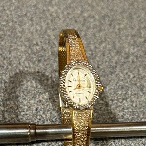 Armitron Women watch with a Gold band Silver and Diamond accents around the dial